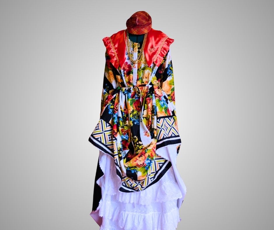 Front view of floral with black and white stripes, authentic Wòb Dwiyèt with orange scarf and white petticoat by Vee’s Couture, Dominica