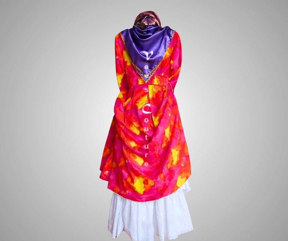 Front view of red and orange/ tie dye authentic Wòb Dwiyèt with violet foula and white petticoat by Vee’s Couture, Dominica