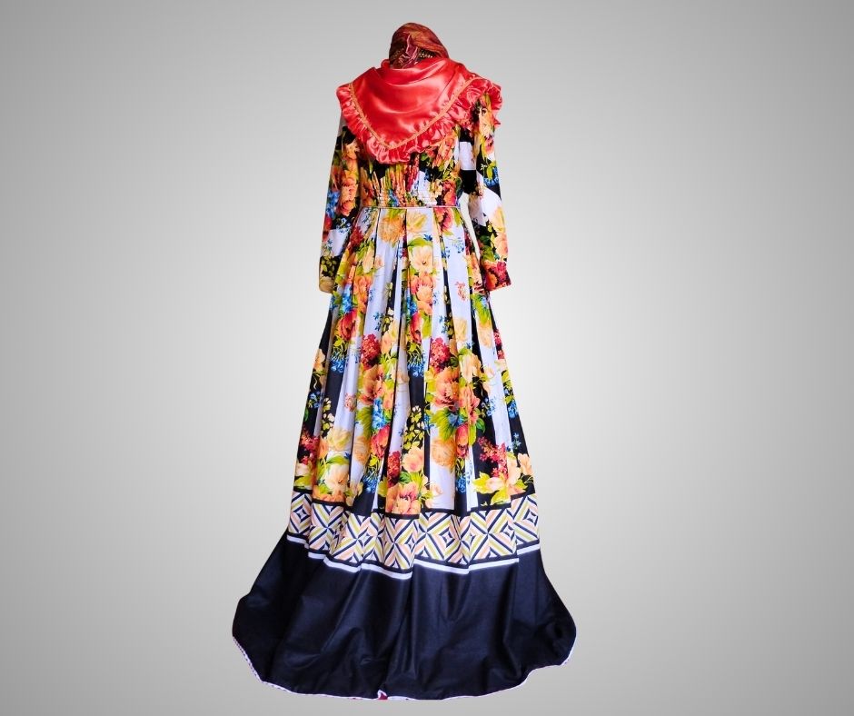 Back view of floral with black and white stripes, authentic Wòb Dwiyèt with orange scarf and white petticoat by Vee’s Couture, Dominica