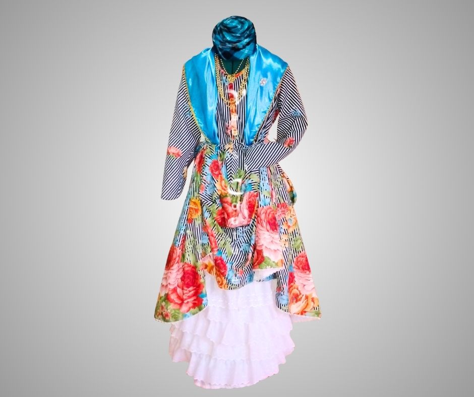 Front view of black and white authentic Wòb Dwiyèt with flowers and blue foula and white petticoat by Vee’s Couture, Dominica 