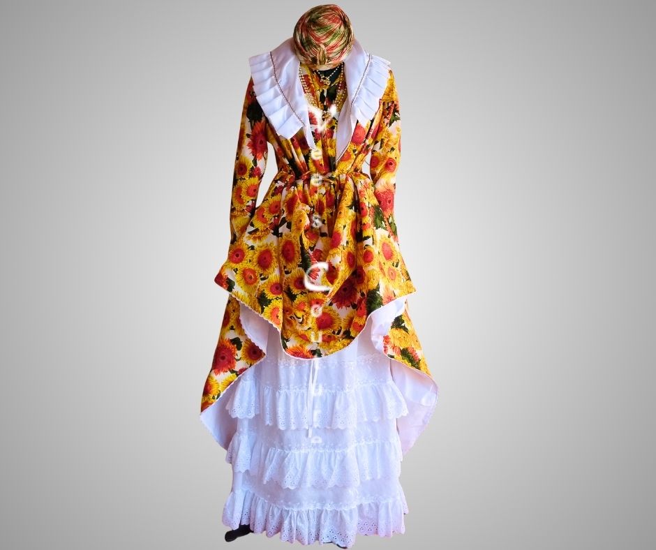 Front view of yellow daisy authentic Wòb Dwiyèt with white foula and white petticoat by Vee’s Couture, Dominica